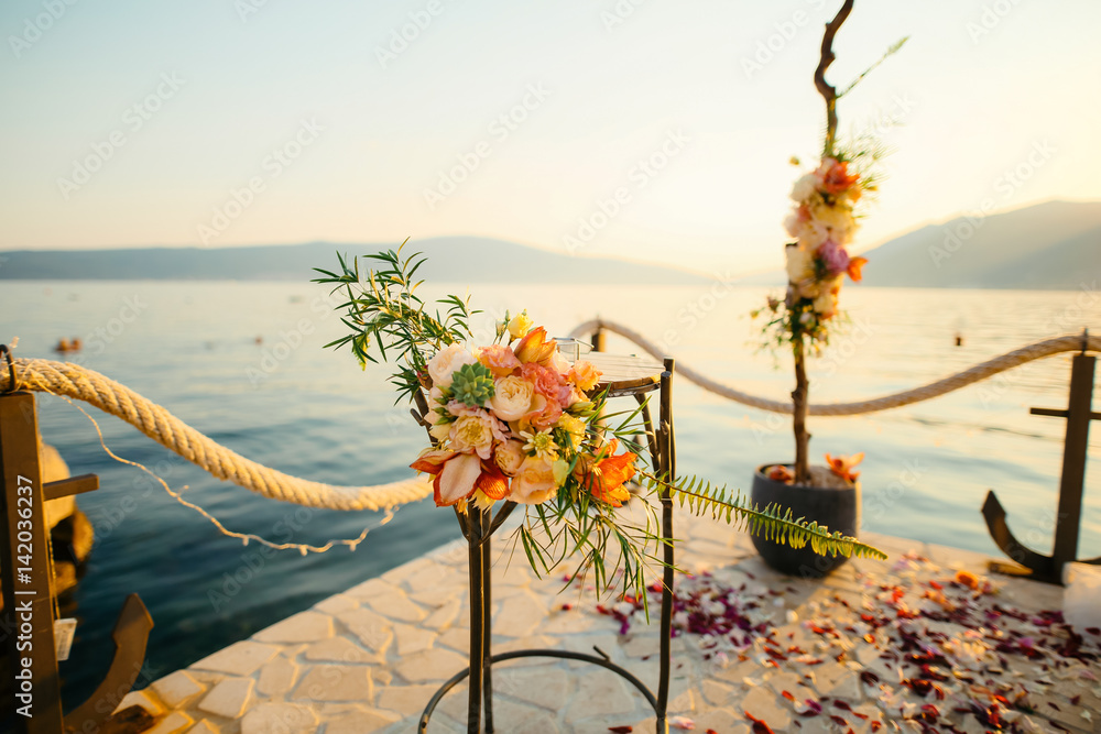 Table for the wedding ceremony, flower arrangement. Wedding decorations. Wedding at the sea in Montenegro.