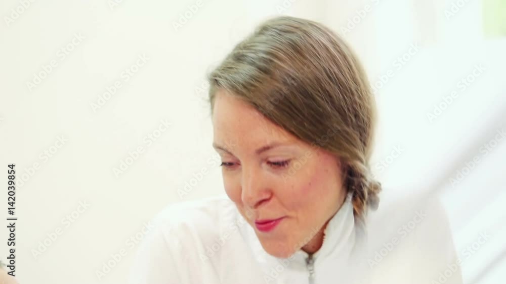 Close up of beautiful female dentist talking with patient in dentist office, graded Close up of beautiful female dentist talking with patient in dentist office, graded
