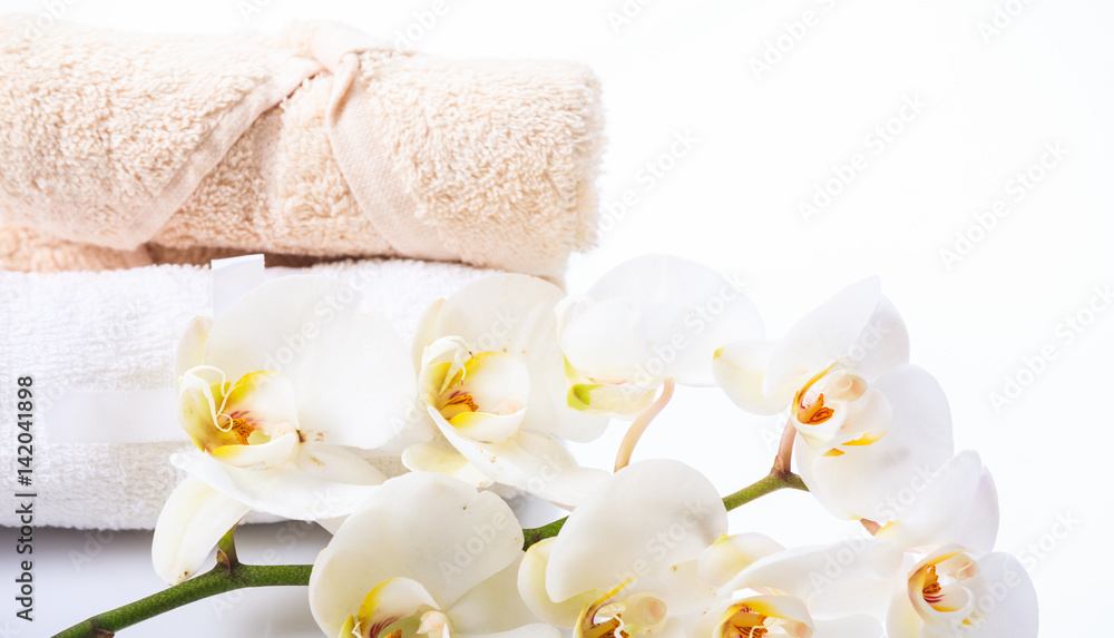 White orchid and towels on white background White orchid and towels on white background