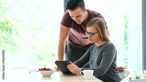 couple enjoying time together while eatinga and using technology photo