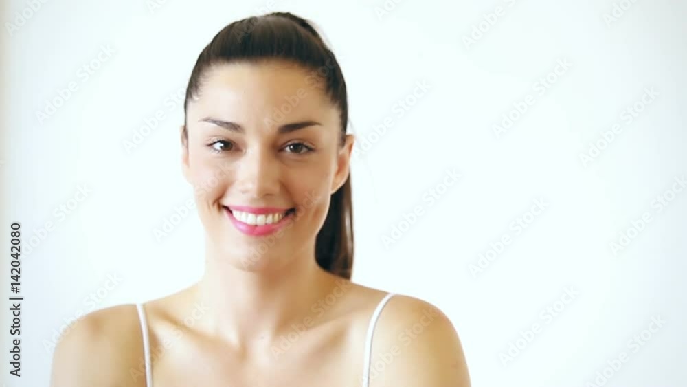 Close up portrait of smiling woman with makeup spinning her head on isolated white background Close up portrait of smiling woman with makeup spinning her head on isolated white background