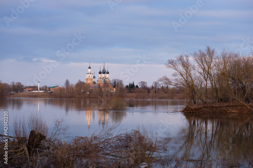 Orthodox temple on the banks of the river at sunset