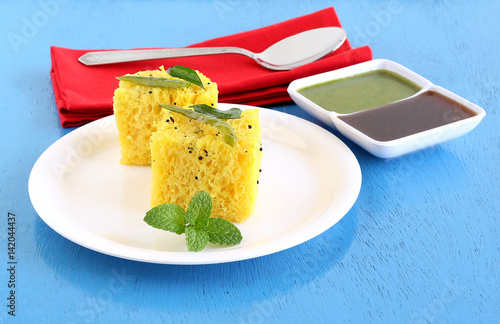 Dhokla, an Indian vegetarian food native to Gujarat state, India, in a plate. photo