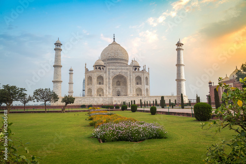 Taj Mahal at sunrise- A white marble mausoleum built on the banks of the Yamuna river by Mughal king Shahjahan bears the heritage of Indian Mughal architecture. photo