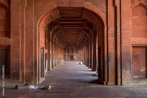 Red sandstone pillar corridor at Fatehpur Sikri Agra. Fatehpur Sikri fort and city showcases Mughal architecture in India and designated as UNESCO world heritage site.