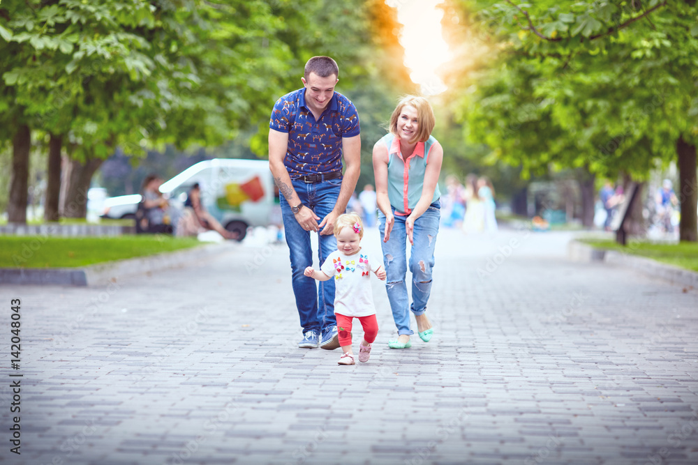 Happy family having weekend in summer park Happy family having weekend in summer park