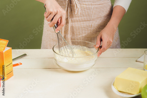 House wife wearing apron making. Steps of making cooking chocolate cake. Preparing dough, mixing ingredients