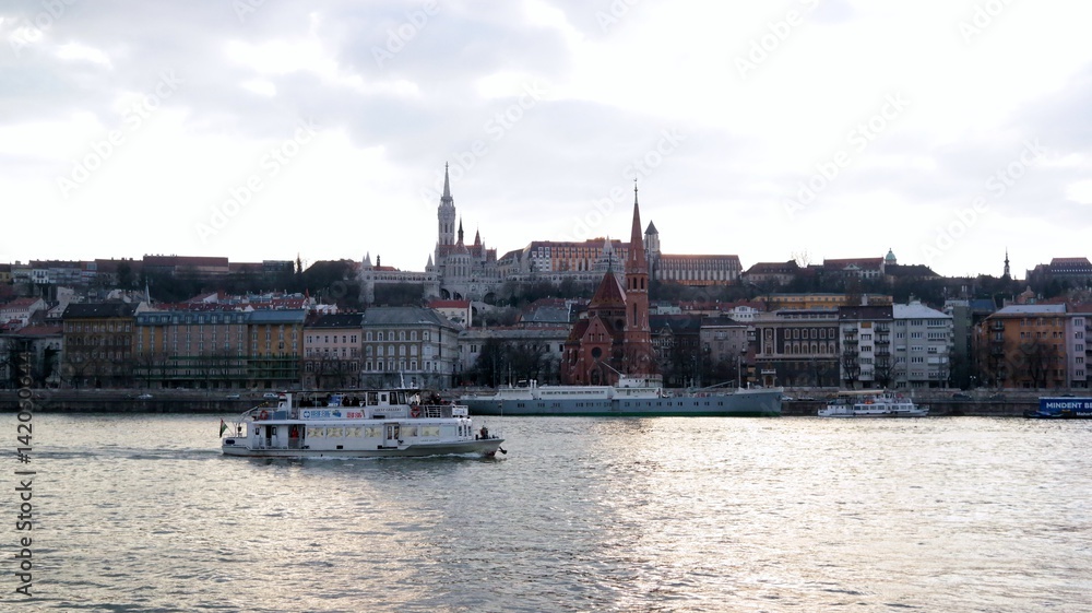 View of Matthias church and Fisheman`s bastion from Danube bank in Budapest, Hungary
