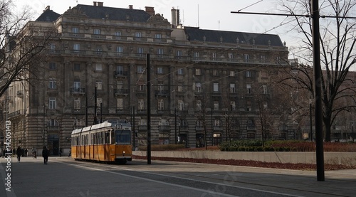 Typical historical yellow tram passing Kossuth Lajos Square in Budapest photo