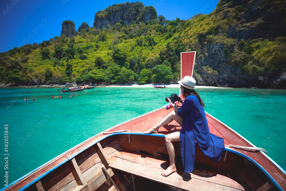 Happy female traveling on boat, Krabi Thailand
