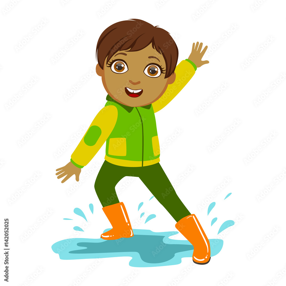 Fototapeta premium Boy In Green And Yellow Jacket, Kid In Autumn Clothes In Fall Season Enjoyingn Rain And Rainy Weather, Splashes And Puddles