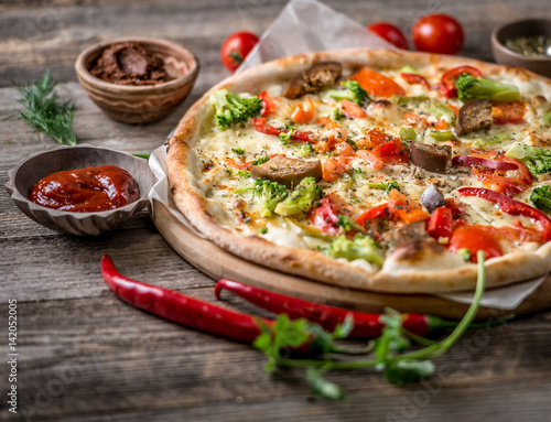 Large vegeterian pizza with sauces and pepper