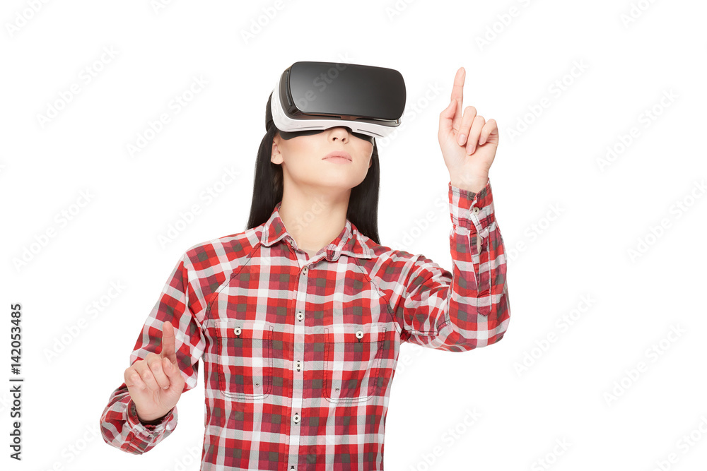 Girl in VR headset making choose and pointing by fingers. Girl in VR headset making choose and pointing by fingers.