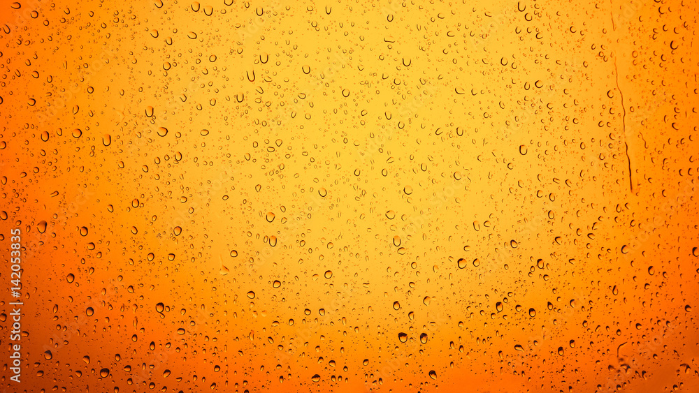 Rain water drop on orange metal.