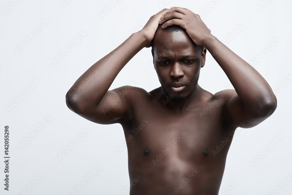 Negative emotion concept stressed man. Closeup headshot very sad depressed, stressed disappointed gloomy young man head on hands screaming in despair isolated on grey wall background. Human emotion Negative emotion concept stressed man. Closeup headshot very sad depressed, stressed disappointed gloomy young man head on hands screaming in despair isolated on grey wall background. Human emotion