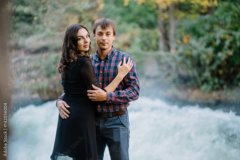 Fototapeta premium pair of beautiful brunette with a guy hugging on the nature