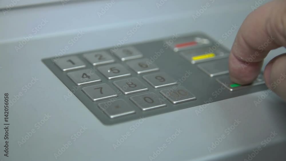 Human hand enter pin code on ATM