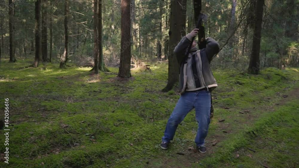 Man walking home with a log on his shoulders Man walking home with a log on his shoulders