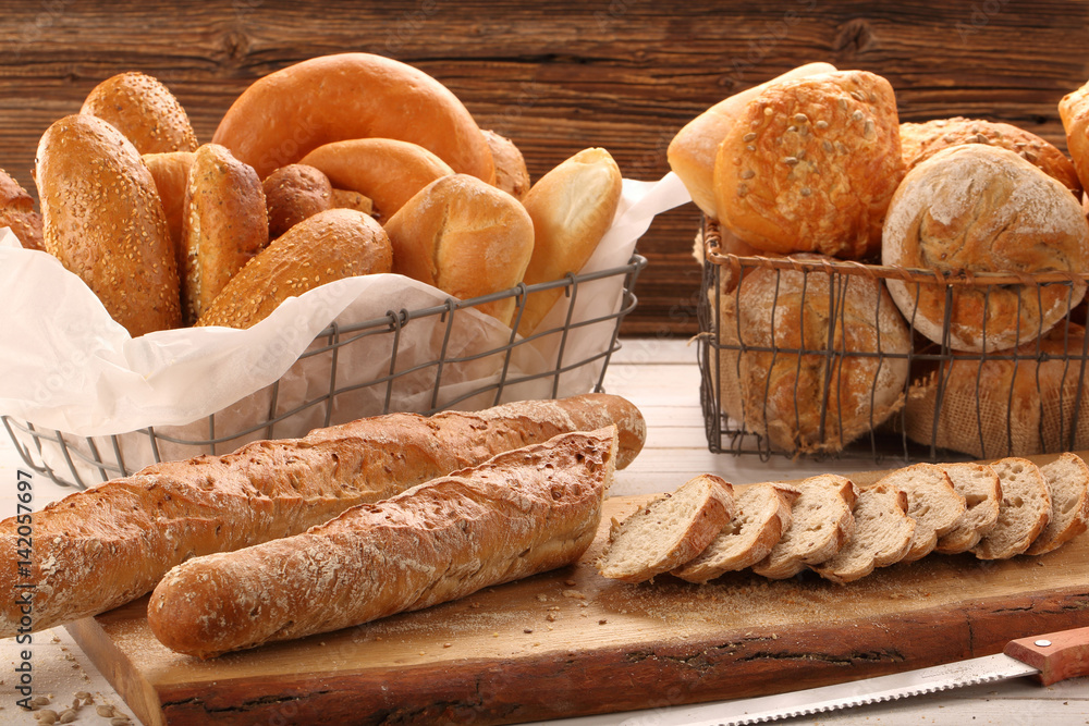 Different types of breads on wooden background