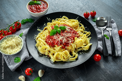 Homemade Hot Pasta with Marinara Sauce  Basil  Garlic  Tomatoes  parmesan cheese on plate.