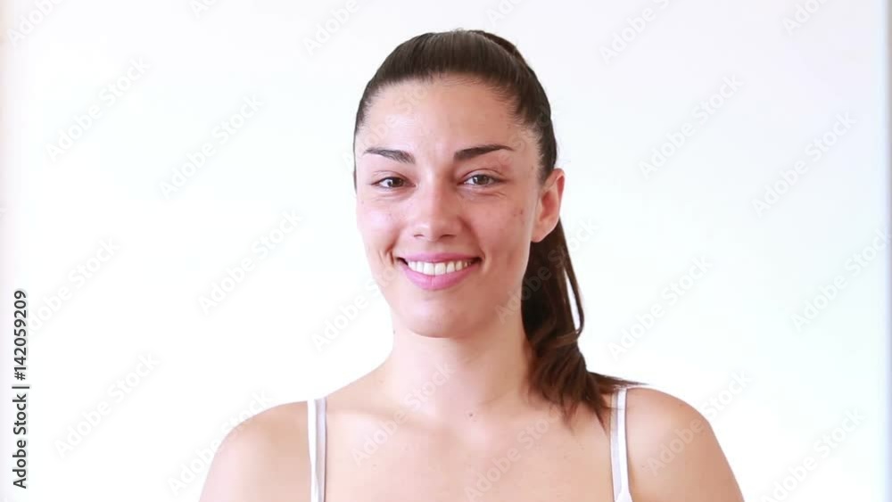 Portrait of smiling brunette woman without makeup on white background Portrait of smiling brunette woman without makeup on white background