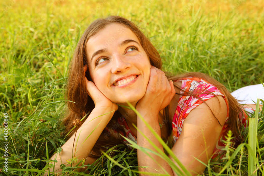 young beautiful girl lays on a grass young beautiful girl lays on a grass