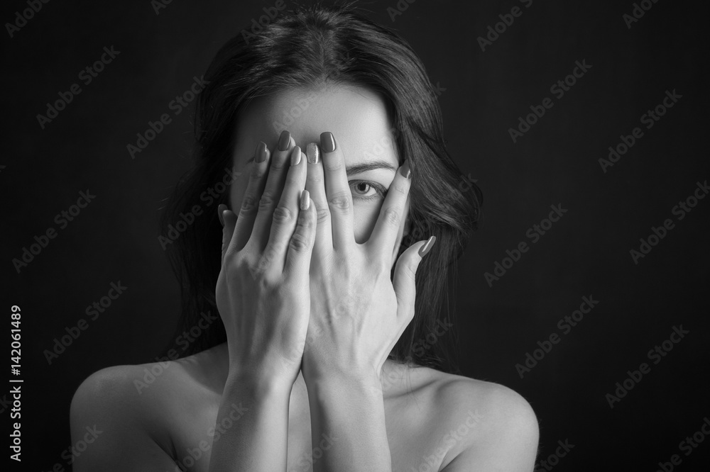 woman cover her face on black background woman cover her face on black background