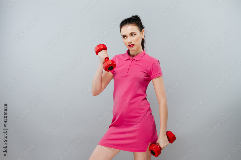 sport and recreation concept - sporty woman hands with light red dumbbells. Pretty girl in sport sport and recreation concept - sporty woman hands with light red dumbbells. Pretty girl in sport