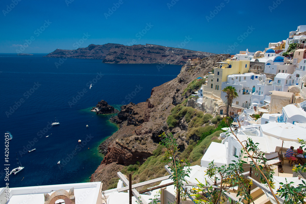 Architecture of island of Santorini, the most romantic island in the world, Greece. Hotels in Santorini. Walking the streets of Fira summer day, Travel to Greece. Beautiful white exterior Santorini 
