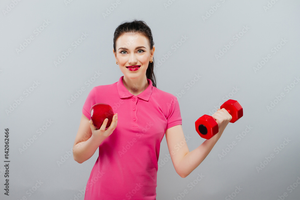 Young Asian woman training muscular and apple of hand with red dumbbells ,kg Young Asian woman training muscular and apple of hand with red dumbbells ,kg