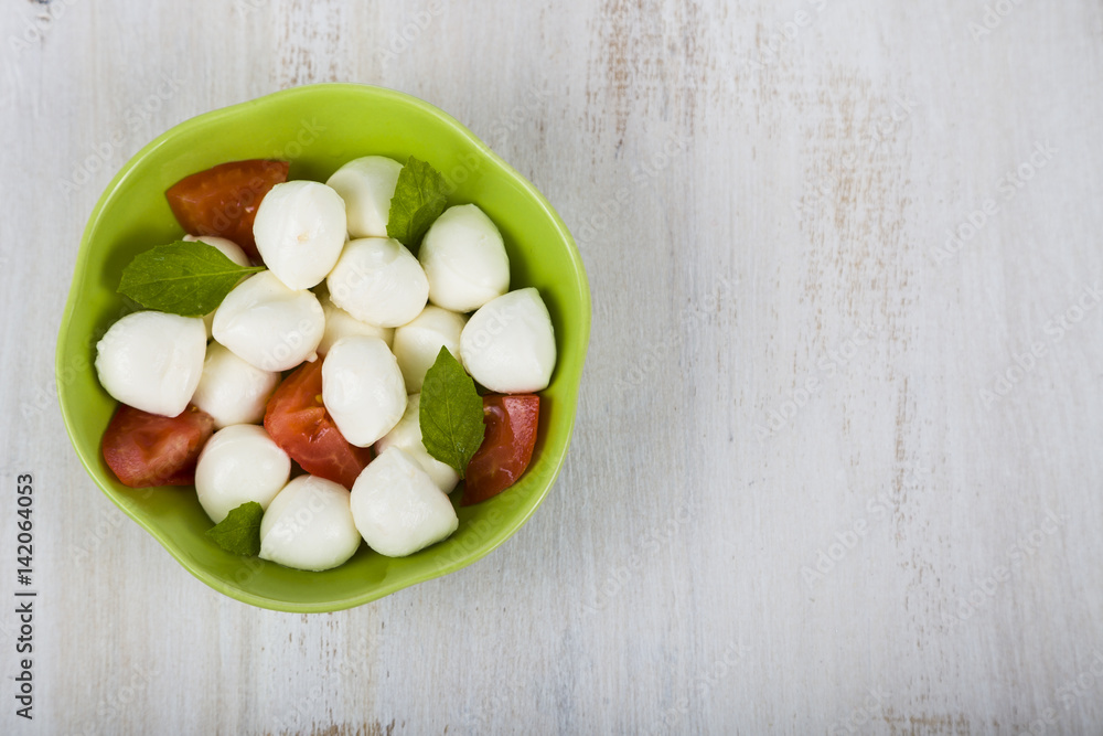 Caprese salad on a wooden table. Caprese salad on a wooden table.