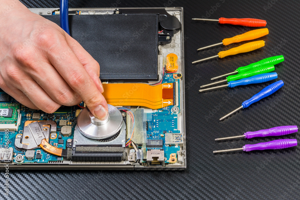person hands diagnostic laptop mainboard with stethoscope on carbon