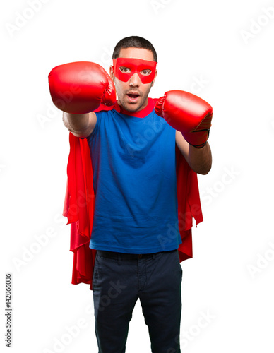 Surprised superhero with a boxing gloves