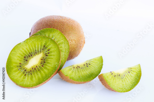 Whole kiwi fruit and his segments isolated on white background cutout