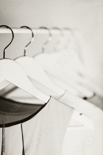 Black-and-white photo with the blur. Women s clothing on a white hanger.