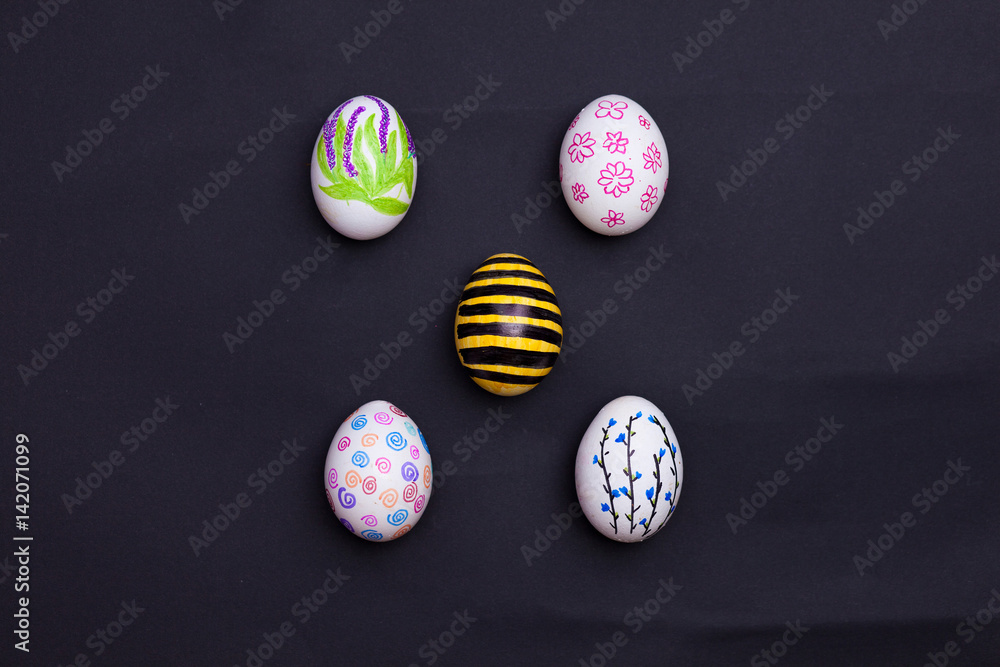 Easter eggs painted on black.