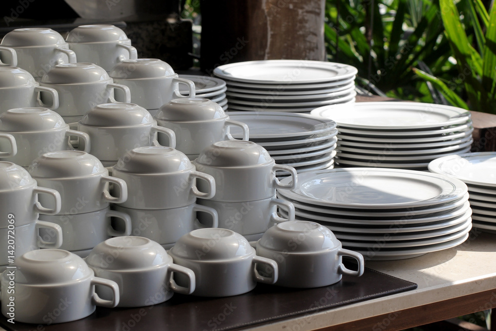 pile of  white ceramic cup and plate