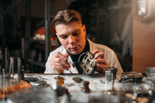 Photos Watchmaker repair old mechanical clocks
