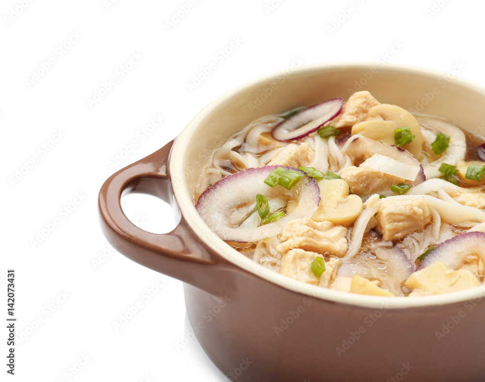 Chicken noodle soup in pot on white background Chicken noodle soup in pot on white background