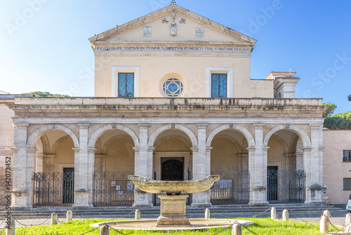 Rome, Italy. The central facade of the church of Santa Maria alla Navicella (VII - XVI centuries) and the fountain in the form of a ship