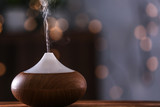 Aroma oil diffuser on blurred background