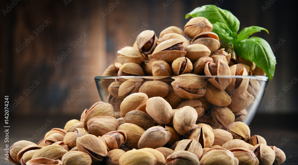 Bowl with pistachio on wooden table Bowl with pistachio on wooden table