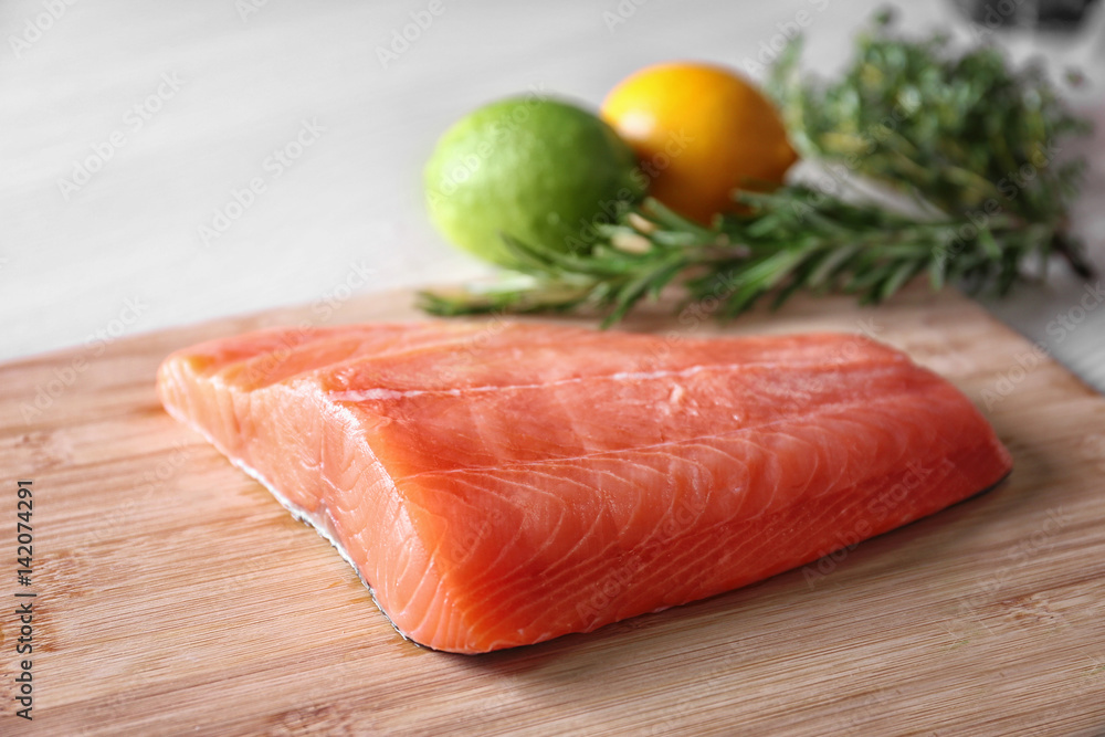 Fresh salmon fillet on wooden cutting board Fresh salmon fillet on wooden cutting board