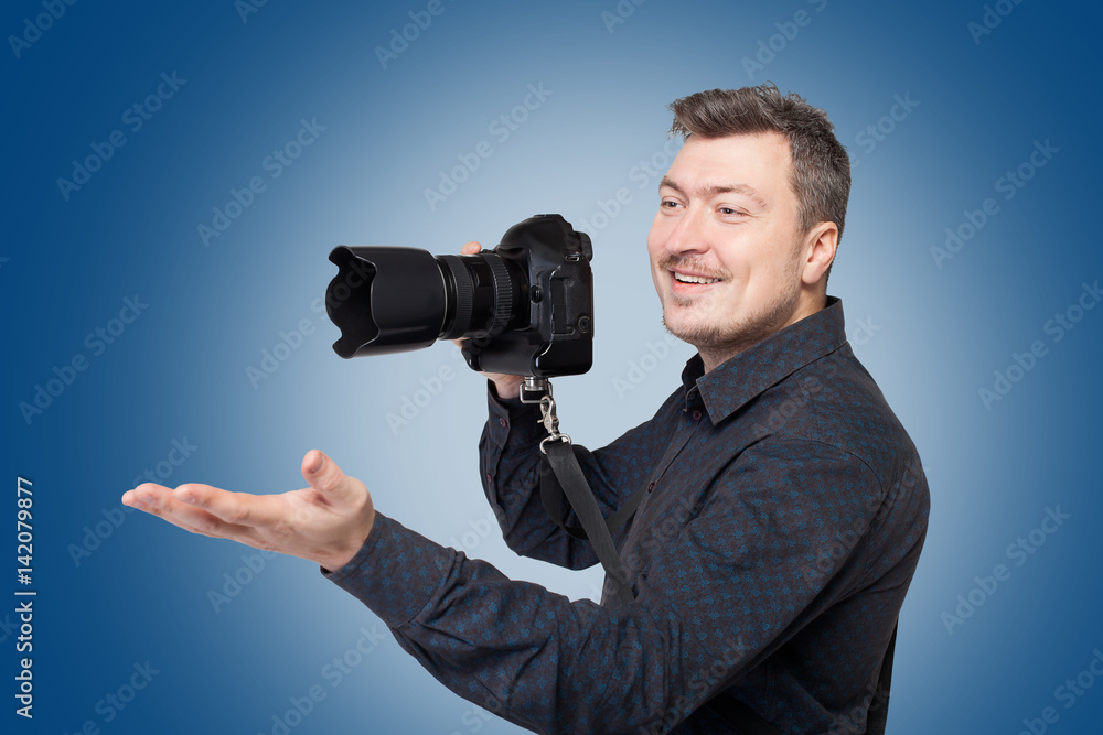 Smiling man with professional digital camera