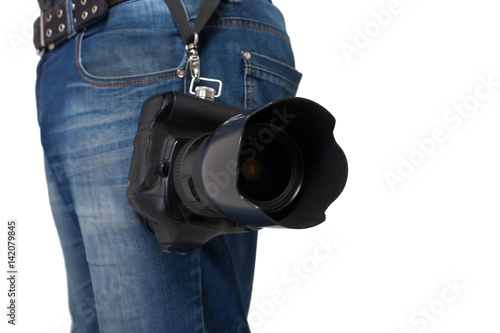 Male legs in jeans and belt holding gigital camera