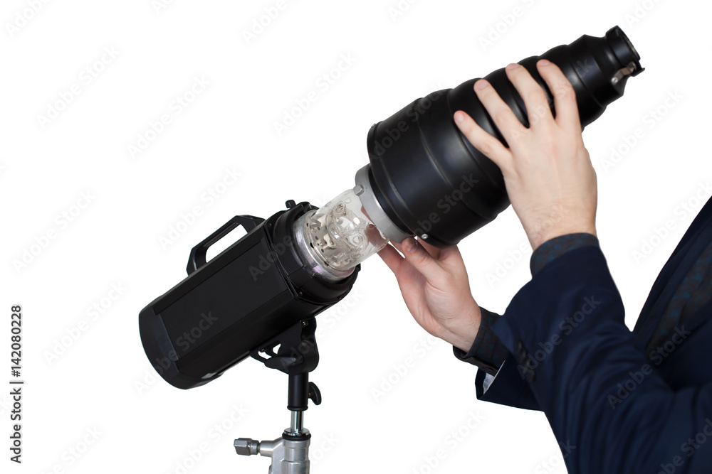 Fototapeta premium Photographer hands adjusts the lighting in studio