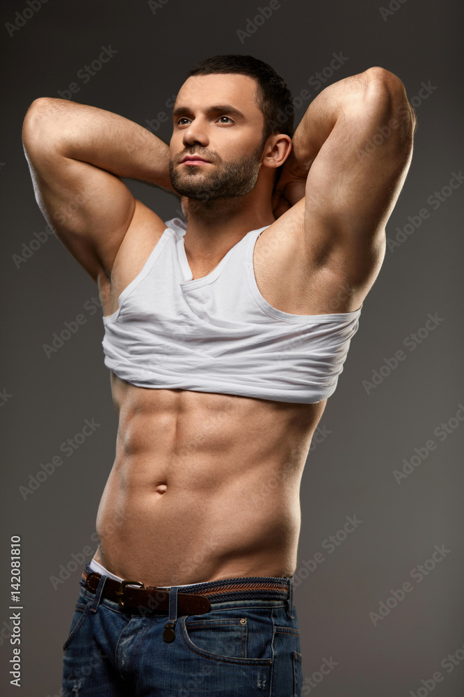 Handsome Athletic Man With Sexy Muscular Body Taking Off Clothes