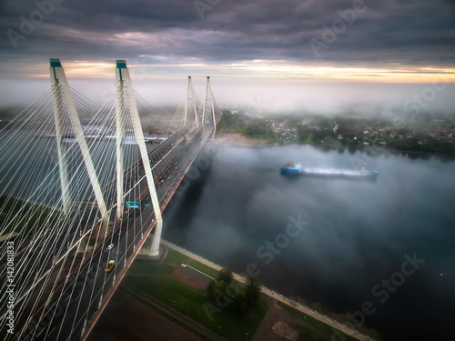 The ship sails under the bridge in the fog. St. Petersburg. The bridge in the fog.