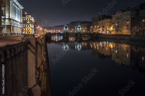 Night city. River in the city. Embankment of the river at night. St. Petersburg. The bridge of Lomonosov.