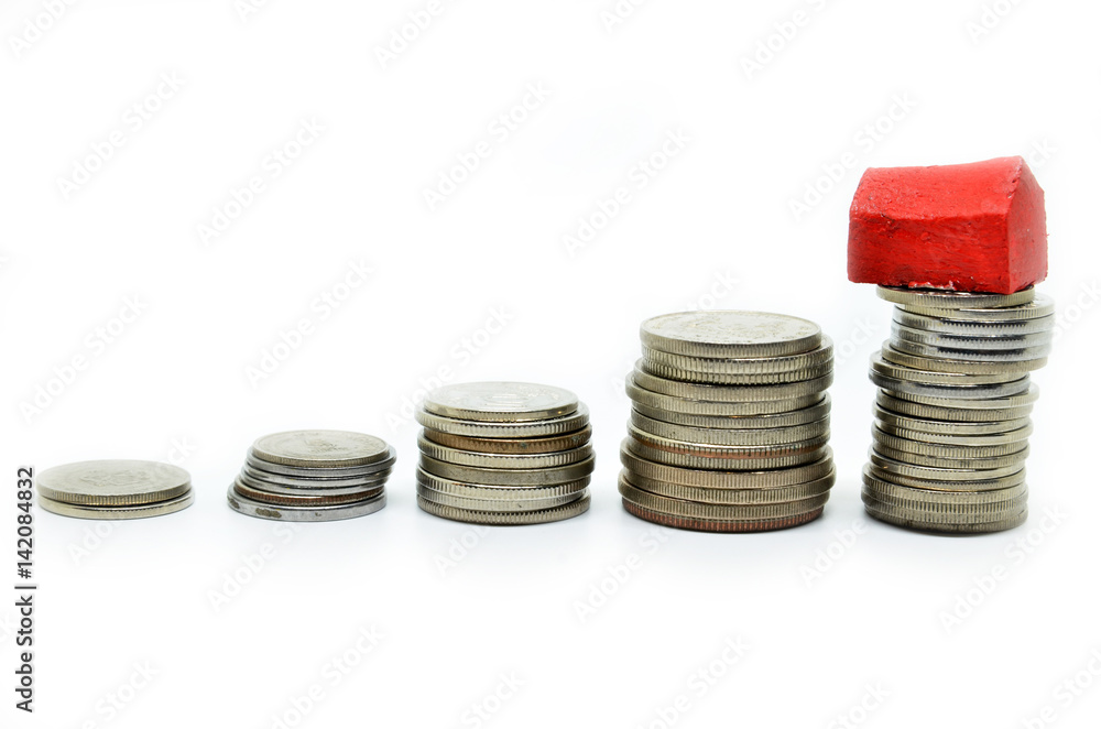 Coins stacked up in piles with color house Coins stacked up in piles with color house